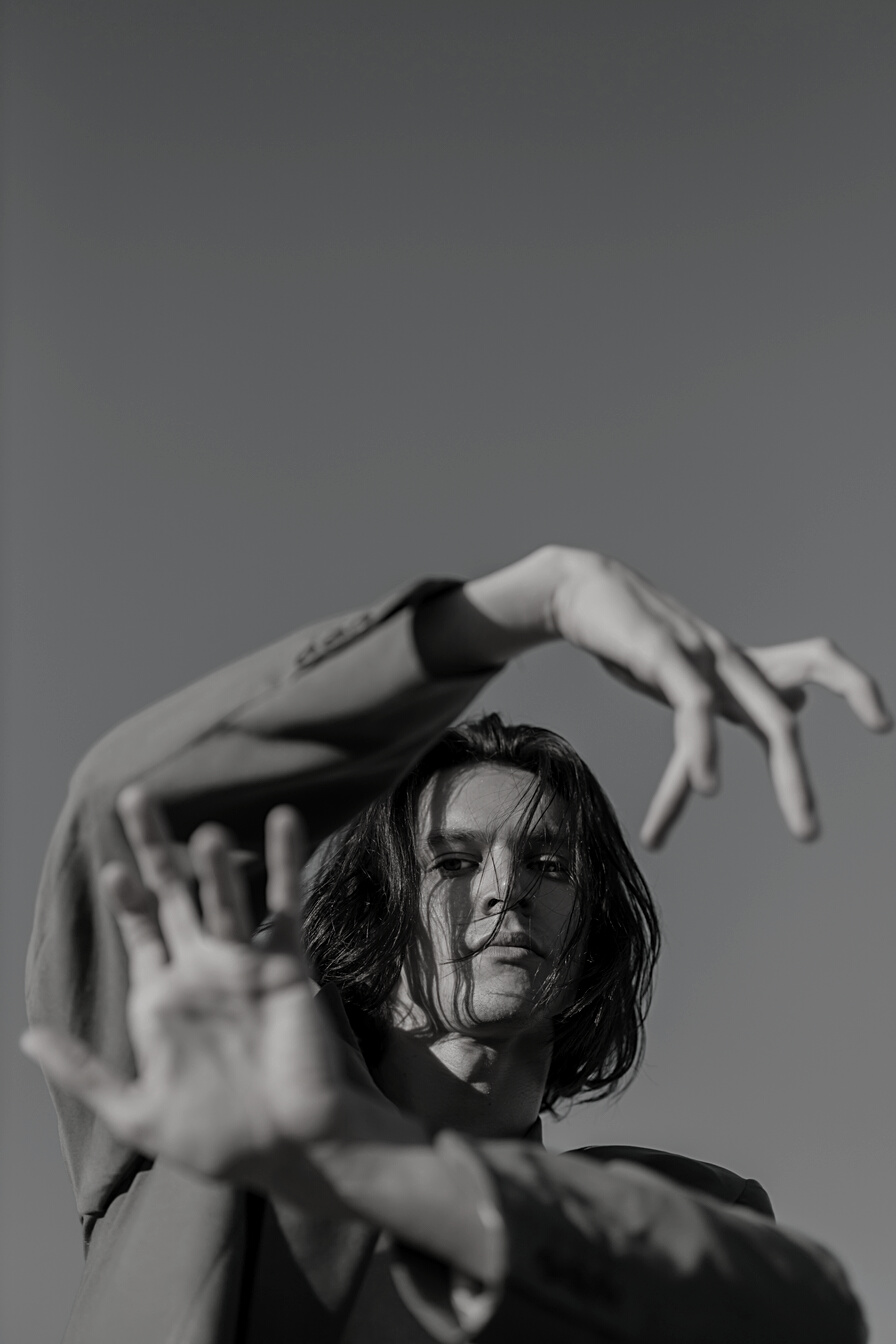 Woman in Black Tank Top Raising Her Hands